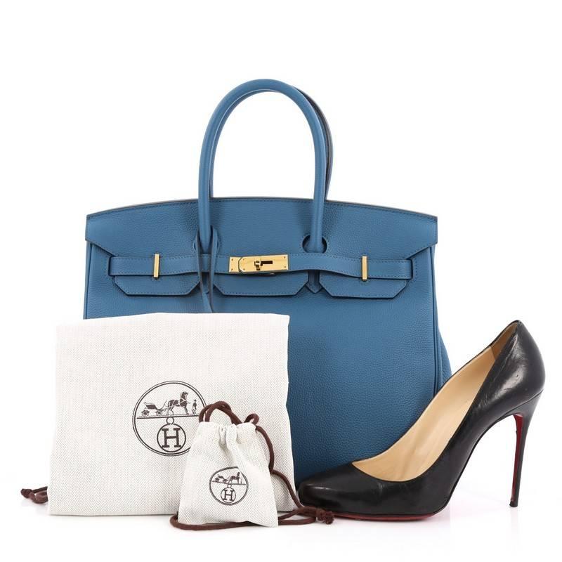 This authentic Hermes Birkin Handbag Bleu Colvert Togo With Gold Hardware 35 stands as one of the most-coveted bags. Crafted from scratch-resistant, iconic blue togo leather, this stand-out tote features dual-rolled top handles, frontal flap, gold