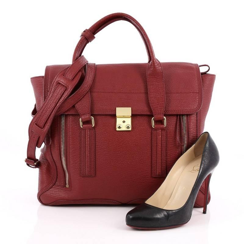 This authentic 3.1 Phillip Lim Pashli Satchel Leather Large is a practical bag with a stylish edge made for on-the-go moments. Crafted from red leather, this chic satchel features dual top handles, expandable zip sides, top flap push-lock closure