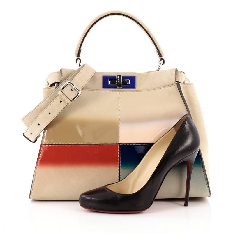 This authentic Fendi Color Block Peekaboo Handbag Patent and Suede Regular is one of Fendi's best known design exuding a luxurious yet minimalist appearance. Crafted in multicolor patent leather and beige suede, this versatile and stylish satchel