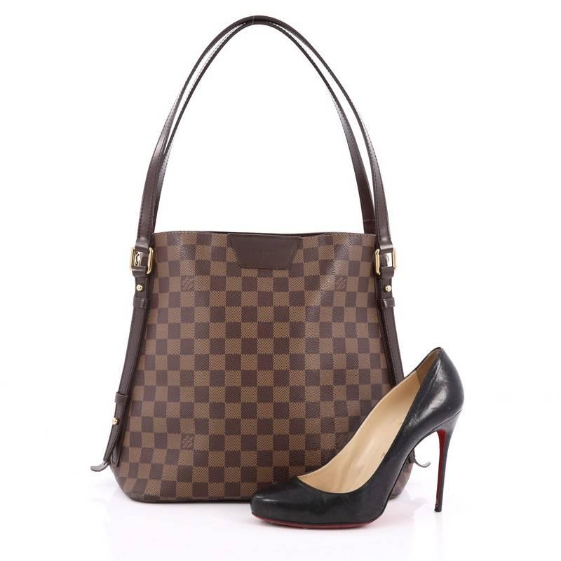 This authentic Louis Vuitton Cabas Rivington Damier has fashion and functionality all rolled into one. Crafted from damier ebene coated canvas with smooth chocolate leather trims, this chic bag features dual flat leather handles, two side zippers