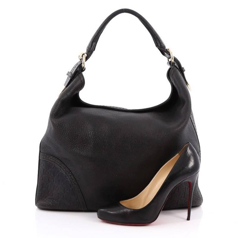 This authentic Gucci Signoria Hobo Leather Large is a classic piece ideal for a casual outfit. Crafted in black leather, this easy-to-carry hobo features a single looped leather handle, guccissima monogram print on base corners and trims and