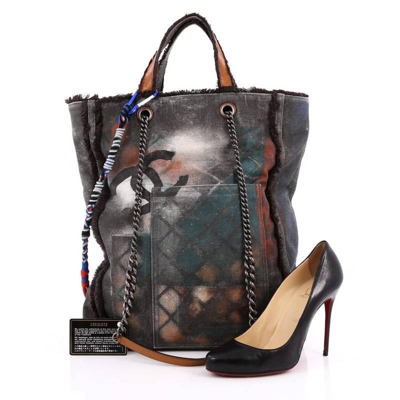 This authentic Chanel Art School Oh My Boy Tote Graffiti Canvas from the brand's Spring/Summer 2014 Bag Collection is the ultimate street-style chic perfect for the modern fashionista. Crafted from grey graffiti printed and sprayed canvas with