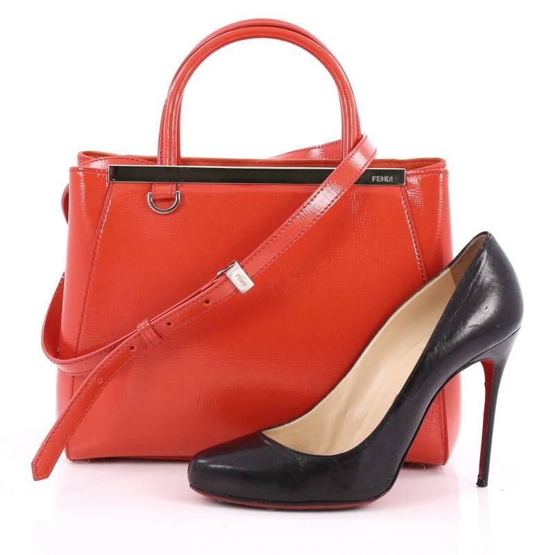 This authentic Fendi 2Jours Handbag Patent Petite is impeccably stylish with its simple silhouette. Crafted from red patent leather, this chic tote features dual-rolled leather handles, a shining top bar with the Fendi brand name, protective base