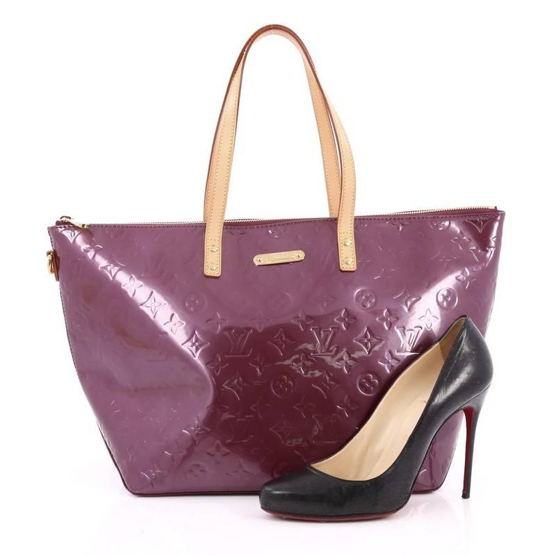 This authentic Louis Vuitton Bellevue Handbag Monogram Vernis GM is stylish yet functional perfect for everyday use. Crafted from Louis Vuitton's violette monogram vernis, this chic tote features vachetta leather handles and gold-tone hardware