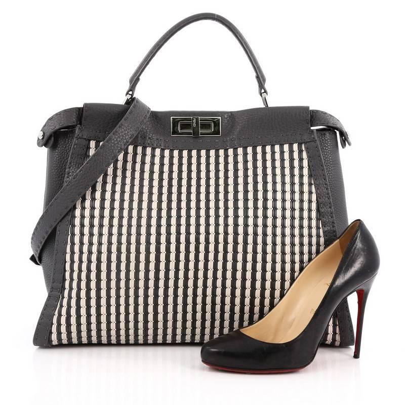 This authentic Fendi Selleria Peekaboo Handbag Woven Leather XL is a stand-out, carry-all piece updating its classic Peekaboo style. Crafted from luxurious gray and white woven leather and grey leather trims, this stylish tote features a short