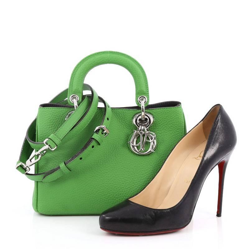 This authentic Christian Dior Diorissimo Tote Pebbled Leather Mini is an elegant, classic statement piece that every fashionista needs in her wardrobe. Crafted from green pebbled leather, this chic tote features smooth short dual handles with sleek