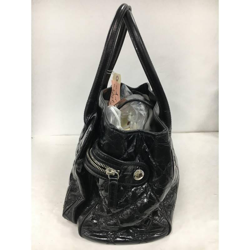 This authentic Chanel Executive Tote Quilted Glazed Calfskin Medium is an ideal everyday accessory for the modern woman. Crafted from beautiful, black quilted glazed calfskin leather, this classic and functional tote features dual-rolled tall