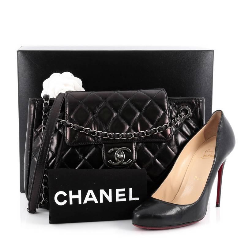 This authentic Chanel Seoul Accordion Flap Bag Glazed Calfskin Large is the perfect polished bag for a day or evening look. Crafted in black glazed quilted calfskin leather, this stylish bag features woven-in leather silver chain straps, Chanel CC