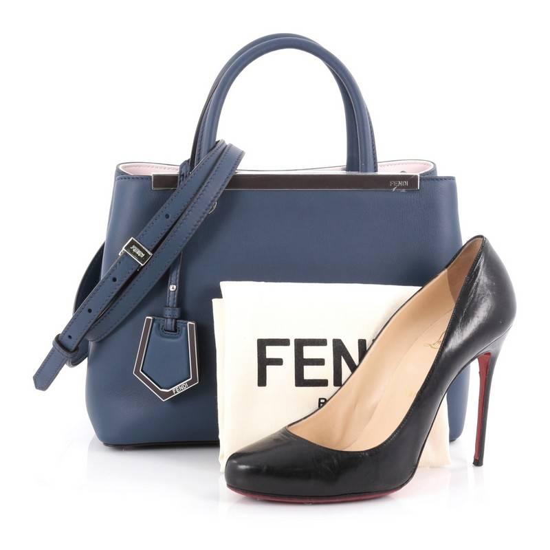This authentic Fendi 2Jours Handbag Leather Petite is impeccably stylish with its simple silhouette. Crafted from blue leather, this chic tote features dual-rolled leather handles, a shining top bar with the Fendi brand name, protective base studs,