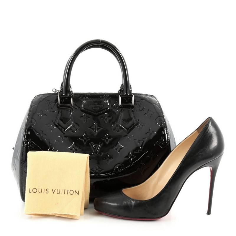 This authentic Louis Vuitton Montana Handbag Monogram Vernis is sophisticated and luxurious in design perfect for everyday use. Crafted in black monogram vernis leather, this feminine-style bowling bag features a rounded silhouette, dual-rolled