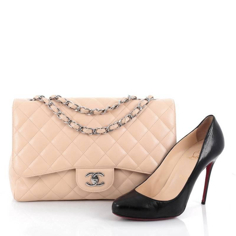 This authentic Chanel Classic Single Flap Bag Quilted Caviar Jumbo is a timeless essential for any modern woman. Crafted in nude quilted caviar leather, this classic flap features woven-in leather chain strap, exterior back pocket, CC signature