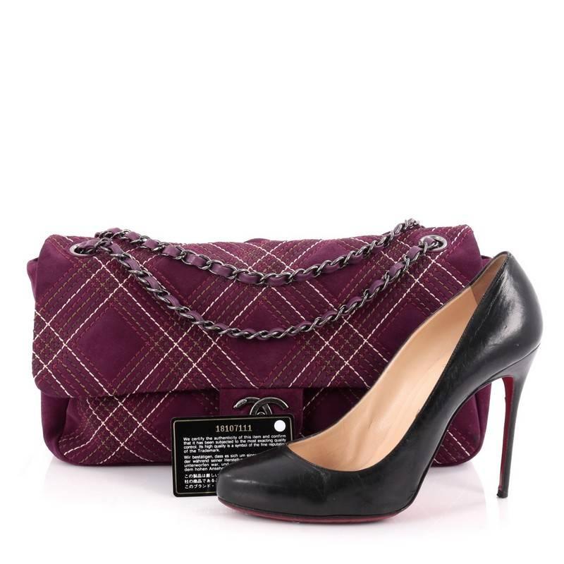 This authentic Chanel Saltire Flap Bag Stitched Suede Medium is ideal for nights out. Crafted in purple suede, this flap bag features contrasting diamond stitches in purple, green, brown and white colors, woven-in leather chain strap and aged