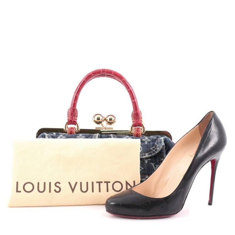 This authentic Louis Vuitton Sac Fermoir Handbag Denim with Alligator GM is a sleek styled bag designed by Marc Jacobs in 2005 for Louis Vuitton and has been a very sought-after bag ever since. Crafted from blue monogram denim, this luxurious bag