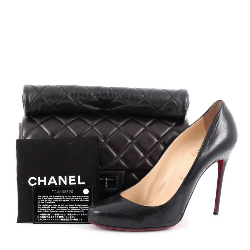 This authentic Chanel Reissue Roll Clutch Quilted Lambskin Medium is ideal for nights out. Crafted in black diamond quilted lambskin leather, this clutch features rolled top handle, frontal flap, exterior back pocket and gunmetal-tone hardware