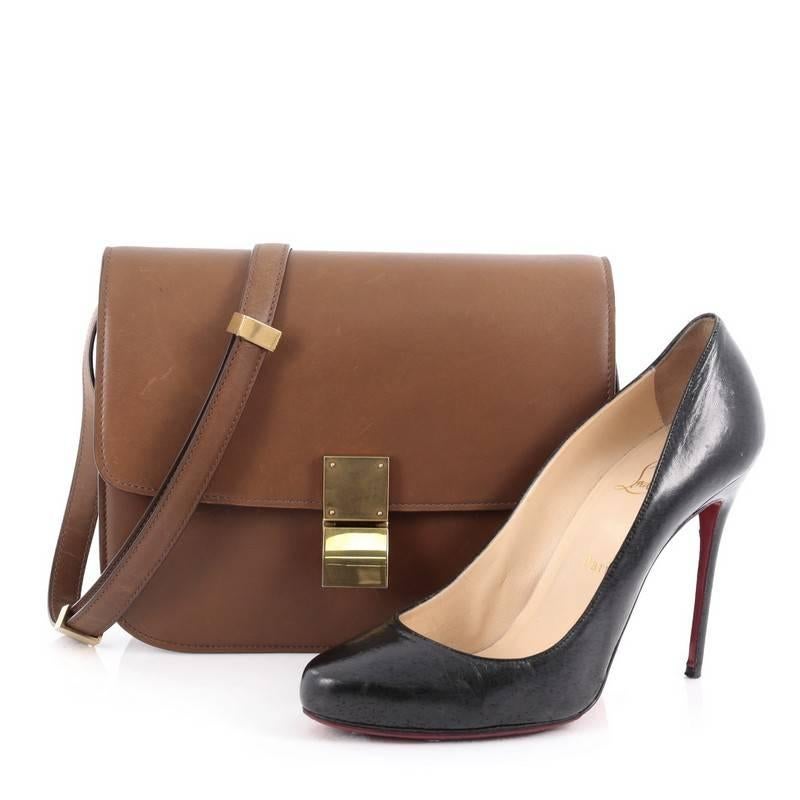 This authentic Celine Box Bag Smooth Leather Medium is a modern reinterpretation to Celine's classic simple box bag. Crafted from smooth brown leather, this sought-after bag features a stamped Celine logo under its flap, long adjustable strap and