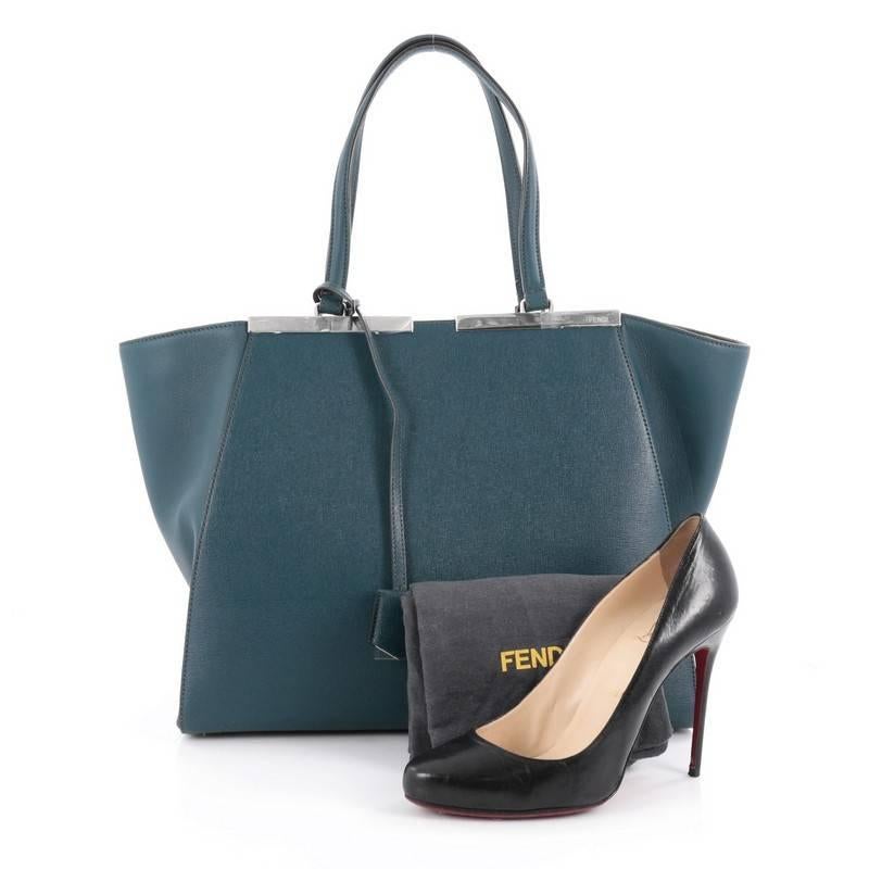 This authentic Fendi 3Jours Handbag Leather Large, updated from its popular predecessor the 2Jour tote, is impeccably stylish. Crafted in dark teal leather, this minimalist tote features a shining split top bar that dons the Fendi brand name, tall