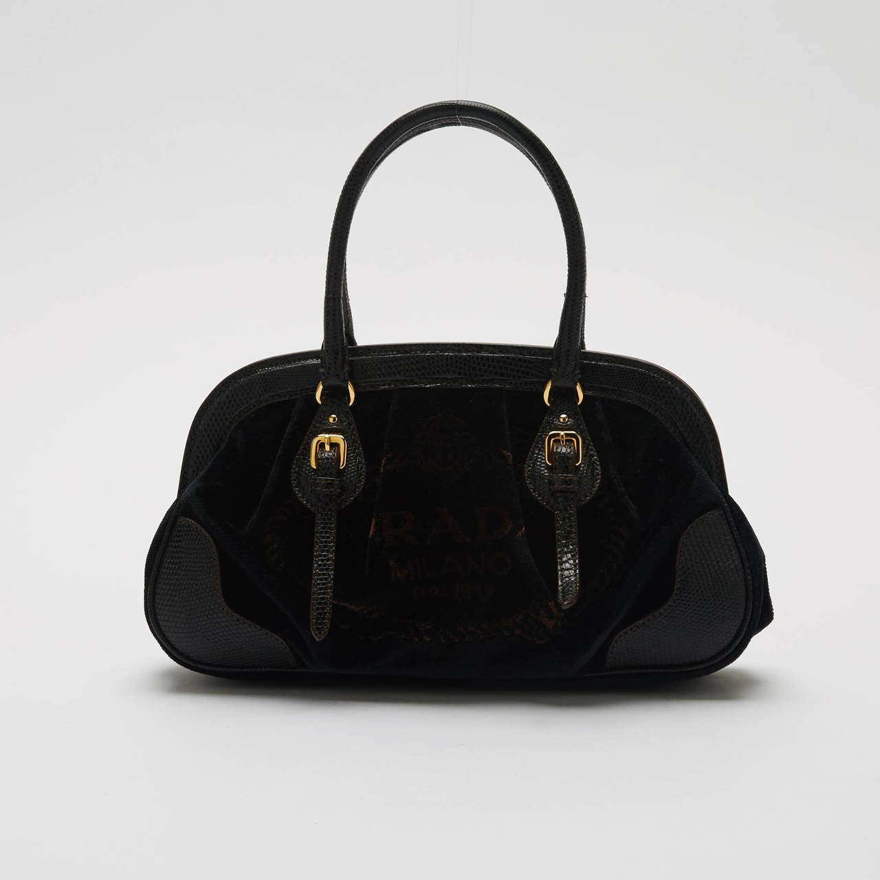 This Prada Frame Bag is detailed with a beautiful deep brown leather trim and handles. It is lovely and pre-owned, adorned with black velvet and gold hardware to accentuate any chic outfit. Sport this authentic petite purse when you want to travel