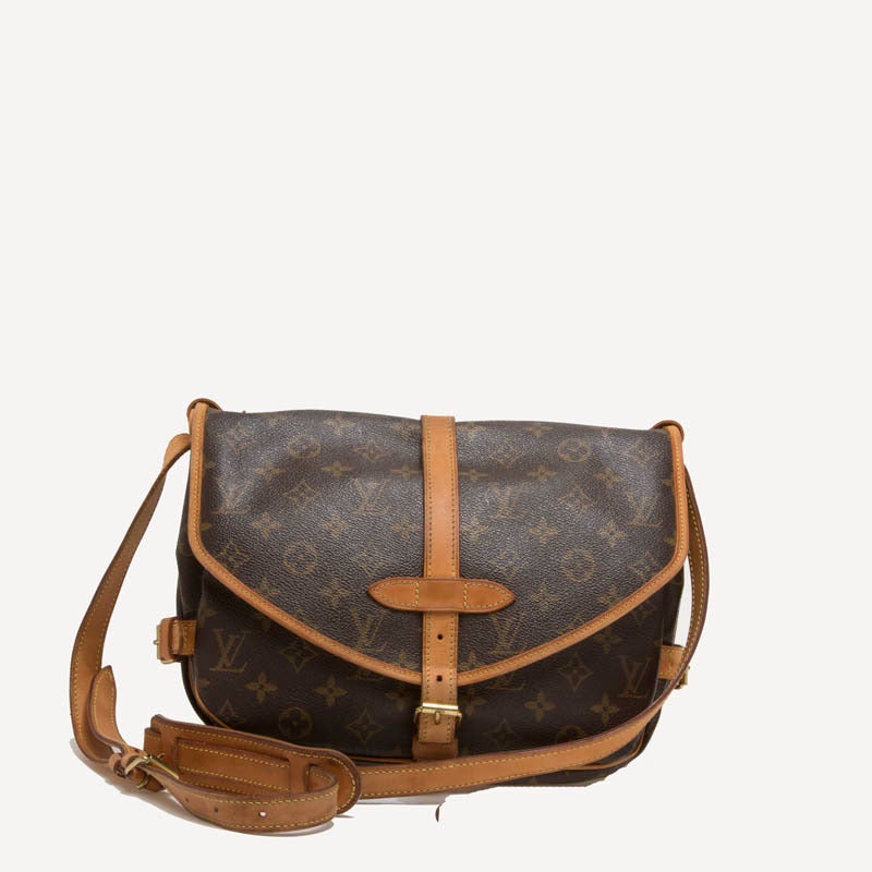 This functional authentic Louis Vuitton Saumur in size MM features double saddle compartments with side buckle leather closures. Its long adjustable straps convert this into a care-free crossbody bag ideal for everyday use. Date tag reads: MB1002