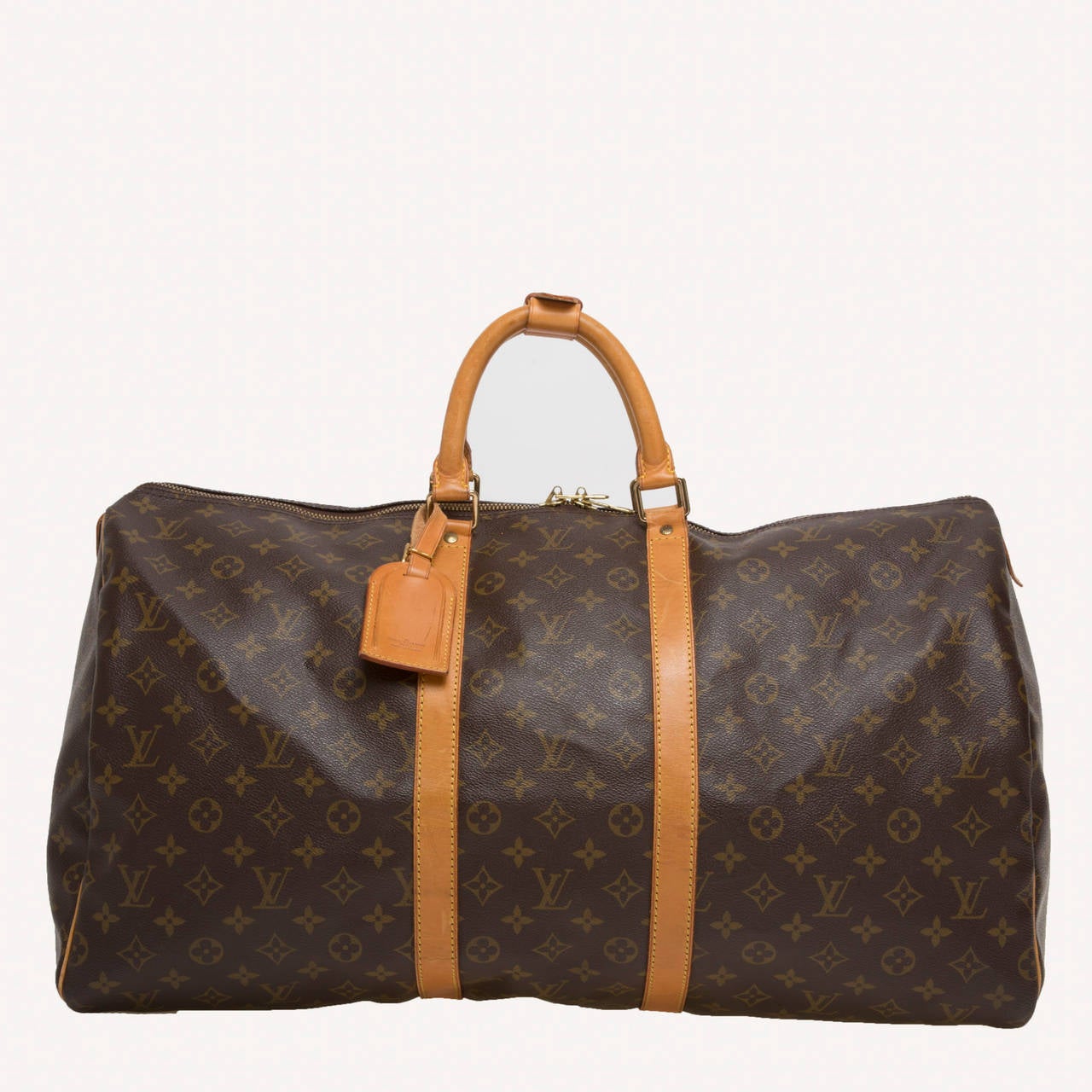 This authentic Louis Vuitton Keepall 55 features the brand's timeless travel bags in monogram canvas print. Its roomy and lightweight interior makes it the perfect travel companion. This duffle accented with brown leather trims comes with a name tag