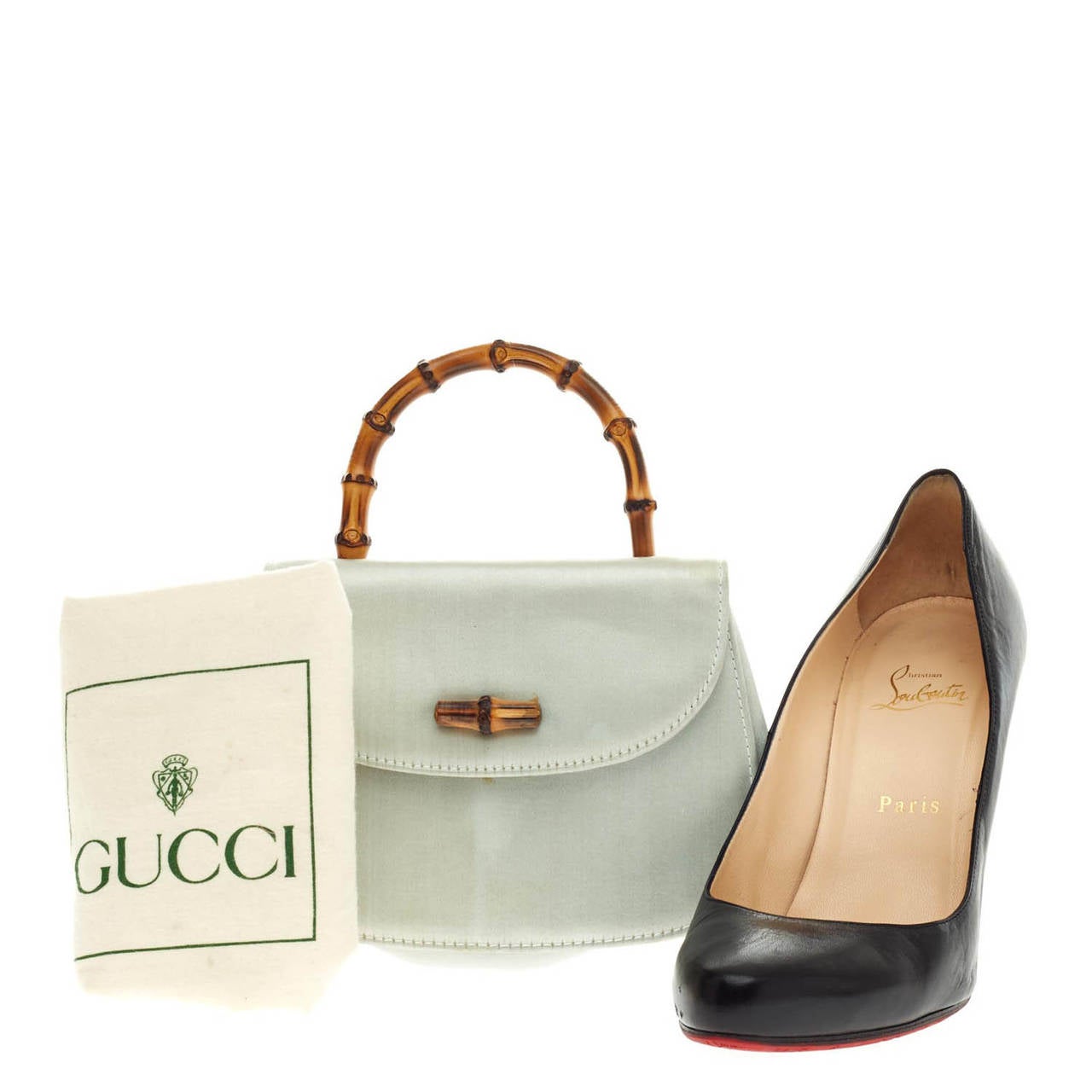 This authentic pre-owned Mini Gucci Bamboo Top Handle is unmistakably a classic Gucci design with its beautiful silvery satin material with undertones of green, and looping bamboo handle. The bamboo turn-lock closure opens to a compact interior and
