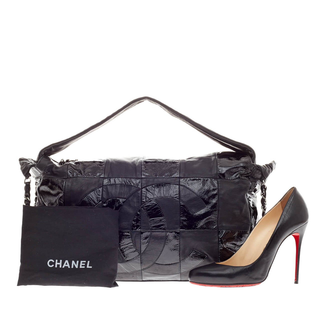 This authentic Chanel Brooklyn Leather Patchwork Convertible Hobo in black is crafted with alternating patches of soft lambskin and patent leather with an oversized patent front CC logo. This bag features a thick end to end leather shoulder strap