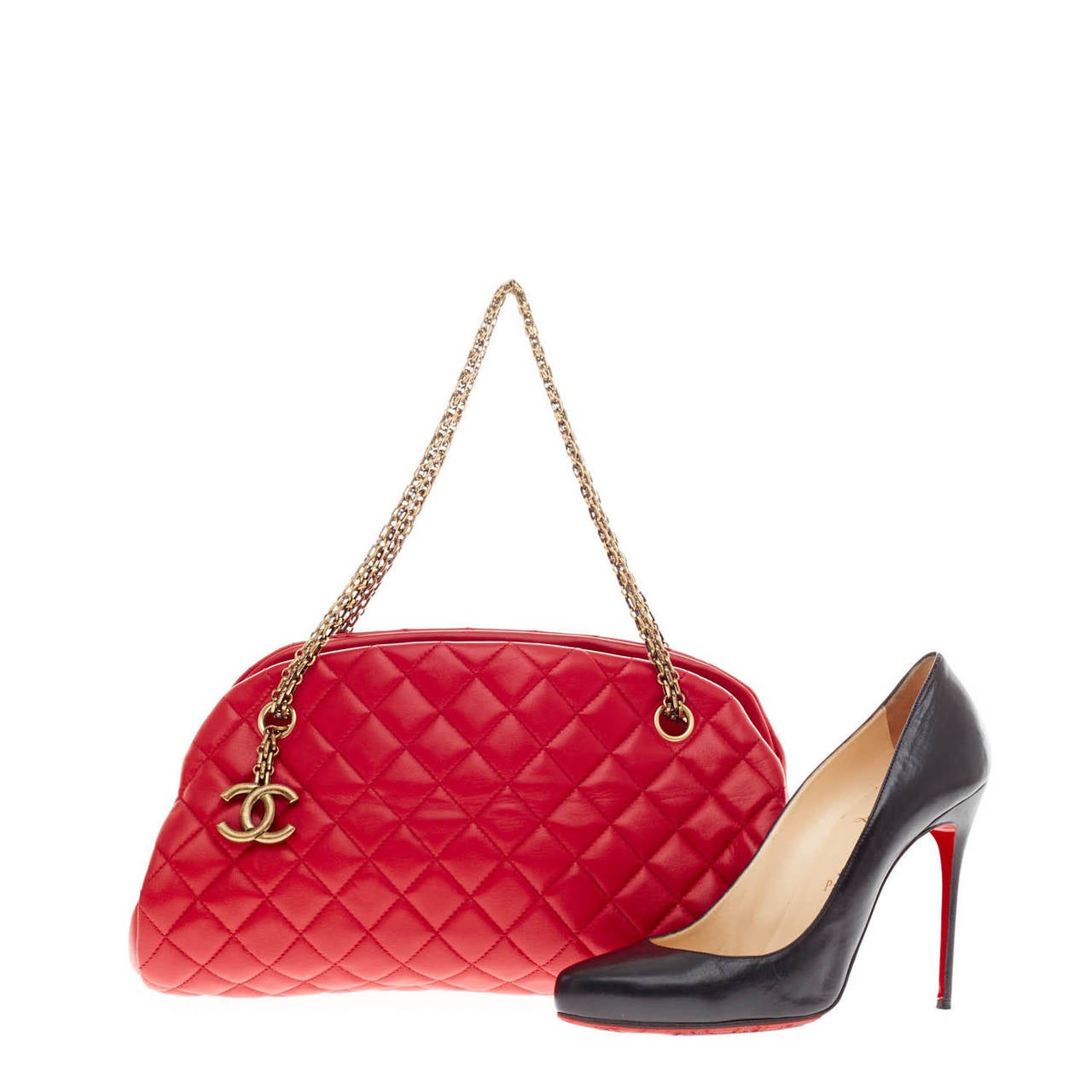 This authentic Chanel Just Mademoiselle Quilted Leather in Medium gives a chic pop of color that complements any look. Crafted from sumptuous red leather in Chanel's iconic diamond stitch pattern, this bag features brass-tone hardware, interlocking