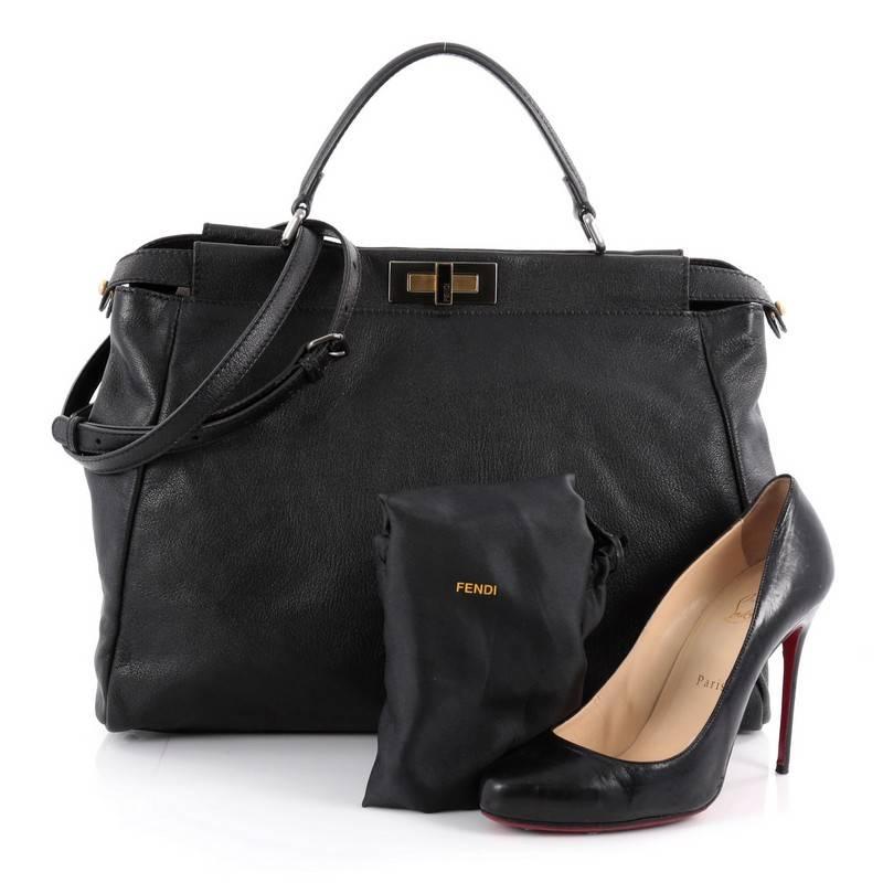 This authentic Fendi Peekaboo Handbag Leather Large is one of Fendi's best known design exuding a luxurious yet minimalist appearance. Crafted in black leather, this versatile and stylish satchel features flat leather top handle, protective base