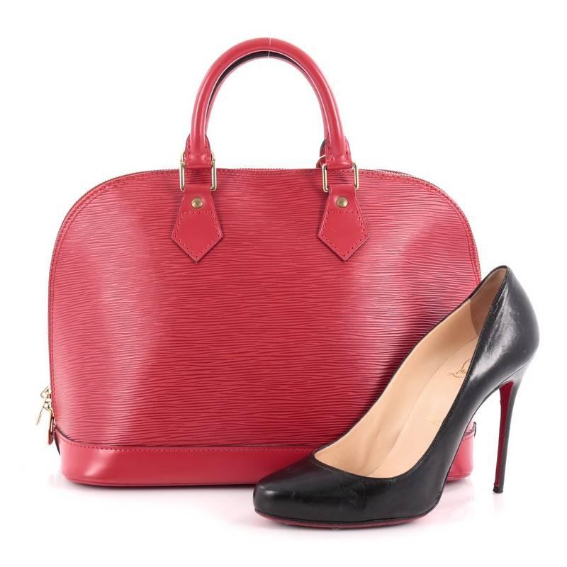 This authentic Louis Vuitton Vintage Alma Handbag Epi Leather PM is a chic and sophisticated bag perfect for your everyday use. Constructed from Louis Vuitton's signature sturdy red epi leather, this bag features dual-rolled leather handles, subtle