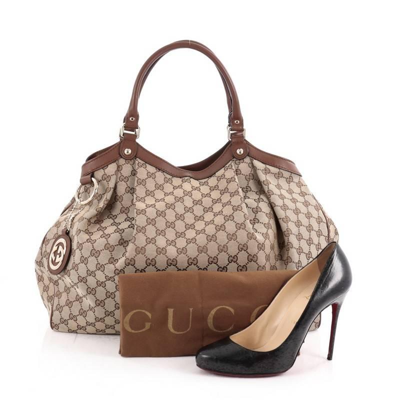 This authentic Gucci Sukey Tote GG Canvas Large is perfect for any casual or sophisticated outfit. Constructed from Gucci's light brown GG fabric with dark brown leather trims, this roomy tote features dual-rolled leather handles that sit