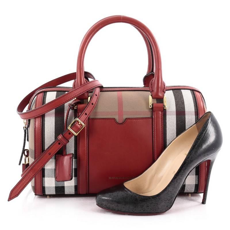 This authentic Burberry Alchester Convertible Satchel House Check and Leather Medium is sophisticated yet classic in design perfect for everyday use. Crafted from Burberry's house check, this petite satchel features red leather trims, dual-rolled