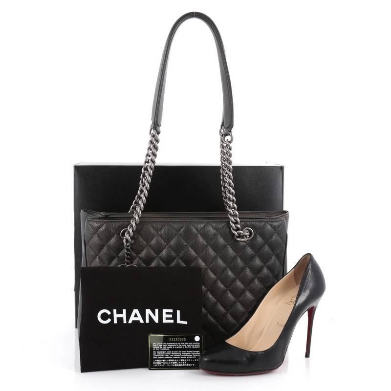 This authentic Chanel Rock in Rome Shopping Tote Quilted Goatskin Large will be your new favorite bag perfect for carrying your things in sophisticated style. Crafted from dark metallic green with copper tones quilted goatskin leather, this chic