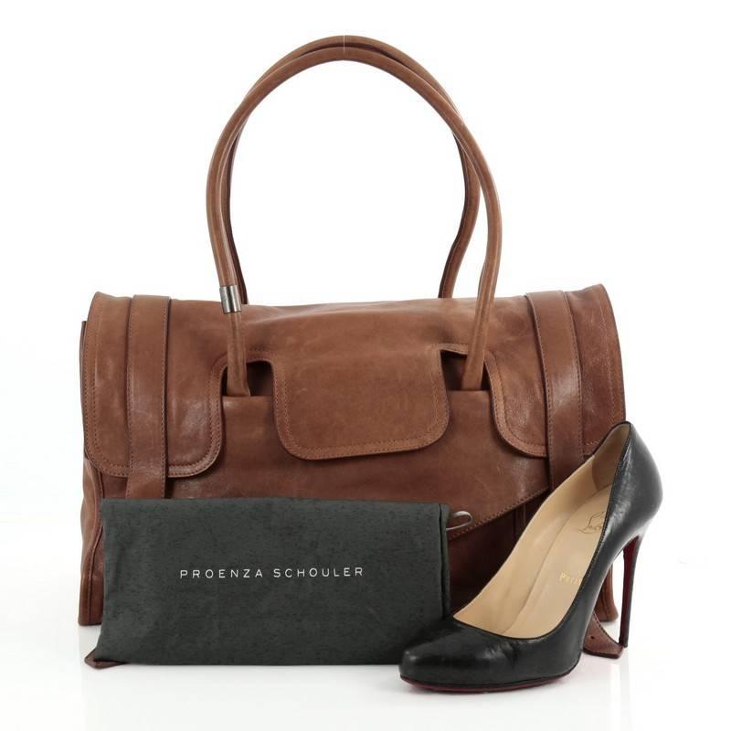 This authentic, Proenza Schouler PS1 Keepall Handbag Leather Large is the ideal way to travel with style and functionality. Crafted from brown leather, this stylish and functional bag features dual-rolled leather handles, a front pocket with