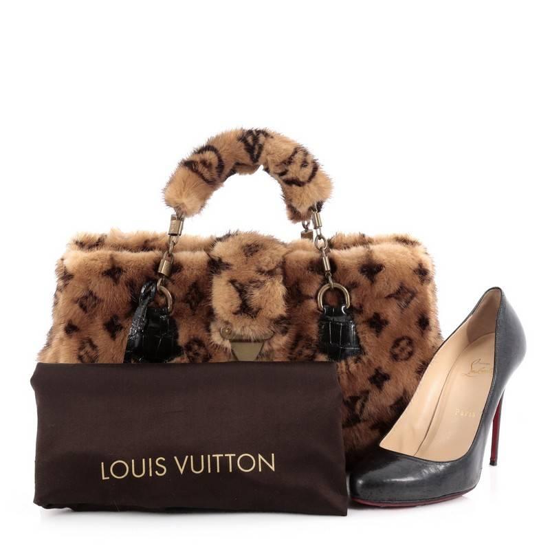 This authentic Louis Vuitton Limited Edition Le Fabuleux Handbag Vision Mink with Alligator is a uniquely styled bag perfect for the chic and fabulous fashionista. Crafted from light brown monogram mink with alligator leather trims, this bag