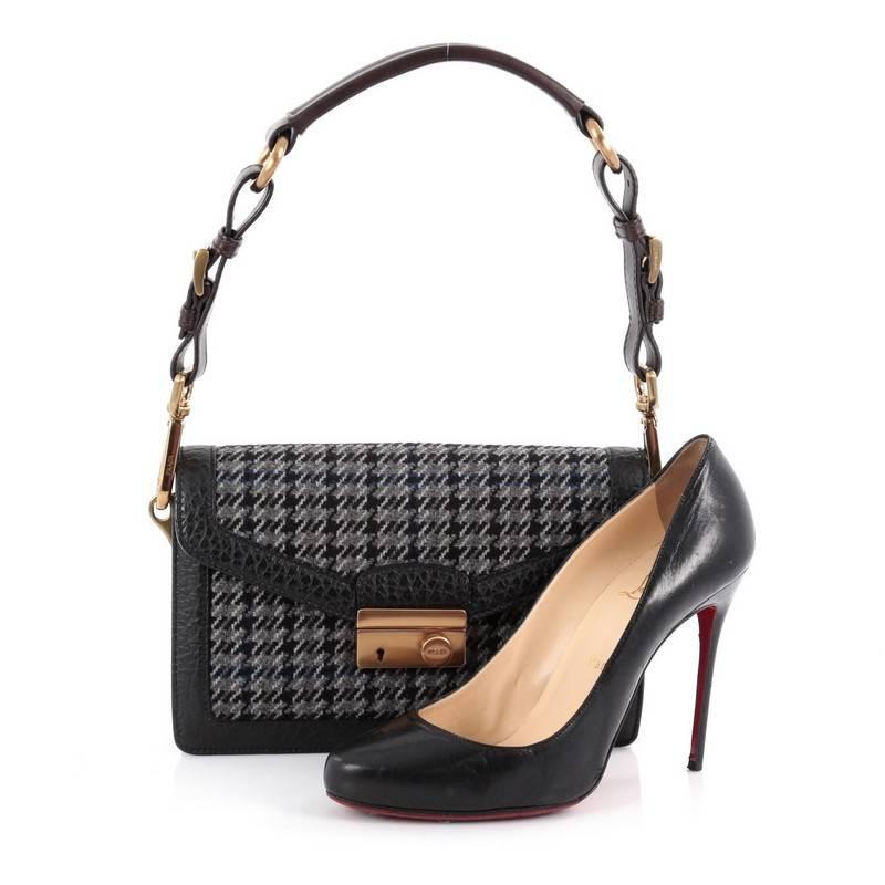 This authentic Prada Sound Bag Tweed Small is your perfect winter accessory. Crafted in grey black and blue tweed and black leather trims, this chic flap features frontal flap with press-lock closure, accordion sides, single loop detachable leather