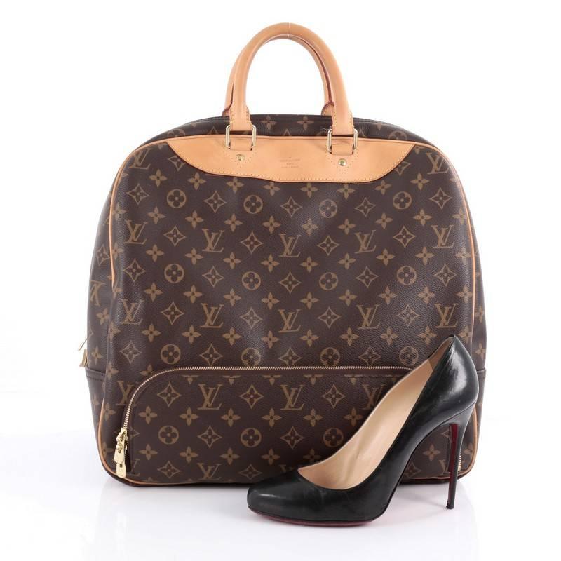 This authentic Louis Vuitton Evasion Travel Bag Monogram Canvas MM is your ideal weekend getaway bag. Crafted from brown monogram coated canvas, this compact size travel bag features dual-rolled leather handles, natural vachetta leather trims,