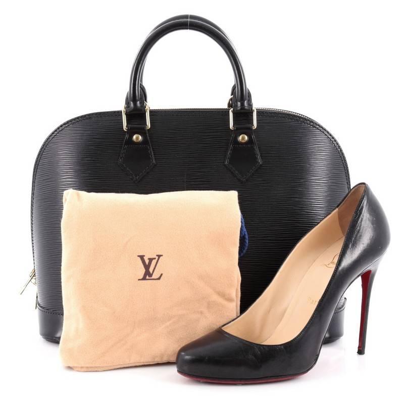 This authentic Louis Vuitton Alma Handbag Epi Leather PM is a chic and sophisticated bag perfect for your everyday use. Constructed from Louis Vuitton's signature sturdy black epi leather, this bag features dual-rolled leather handles, subtle LV