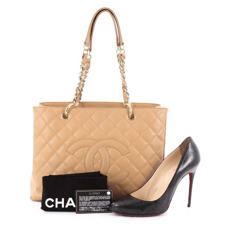 This authentic Chanel Grand Shopping Tote Quilted Caviar is perfect for everyday use with a classic yet luxurious style. Crafted in light brown diamond quilted caviar leather, this versatile, timeless tote features a stitched CC in the middle,