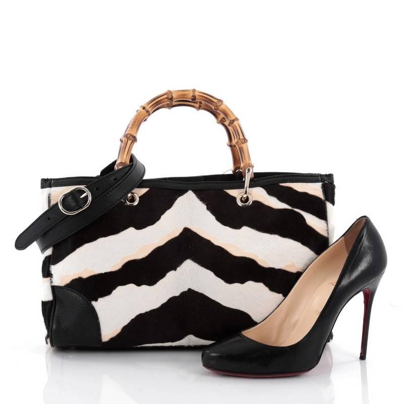 This authentic Gucci Bamboo Shopper Tote Pony Hair with Leather Medium is a classic must-have. Crafted from genuine black, white and beige pony hair with black leather trims, this simple yet stylish tote features Gucci's signature sturdy bamboo
