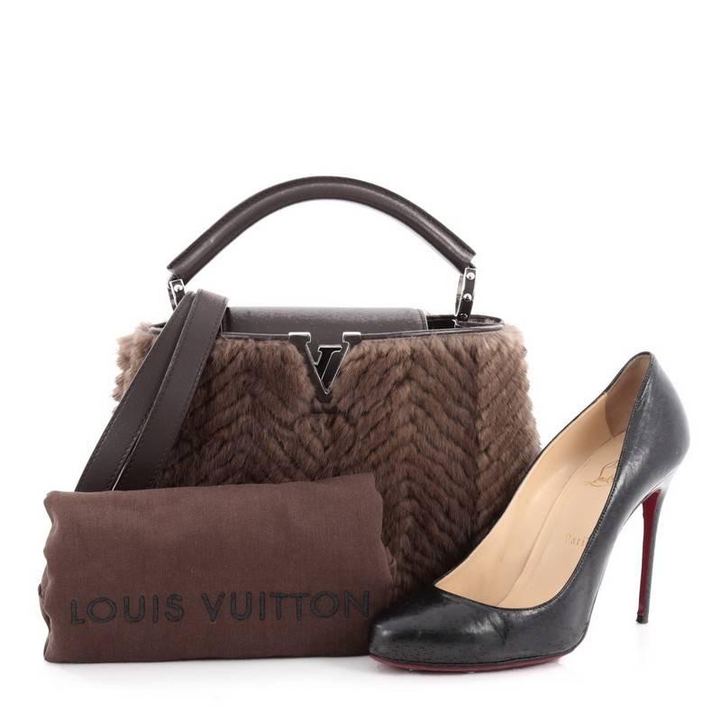 This authentic Louis Vuitton Capucines Fur BB displays an exalted level of craftsmanship perfect for the stylish fashionista. Crafted from brown genuine fur, this ultra-chic petite bag features a single rolled leather handle secured by jewel-like