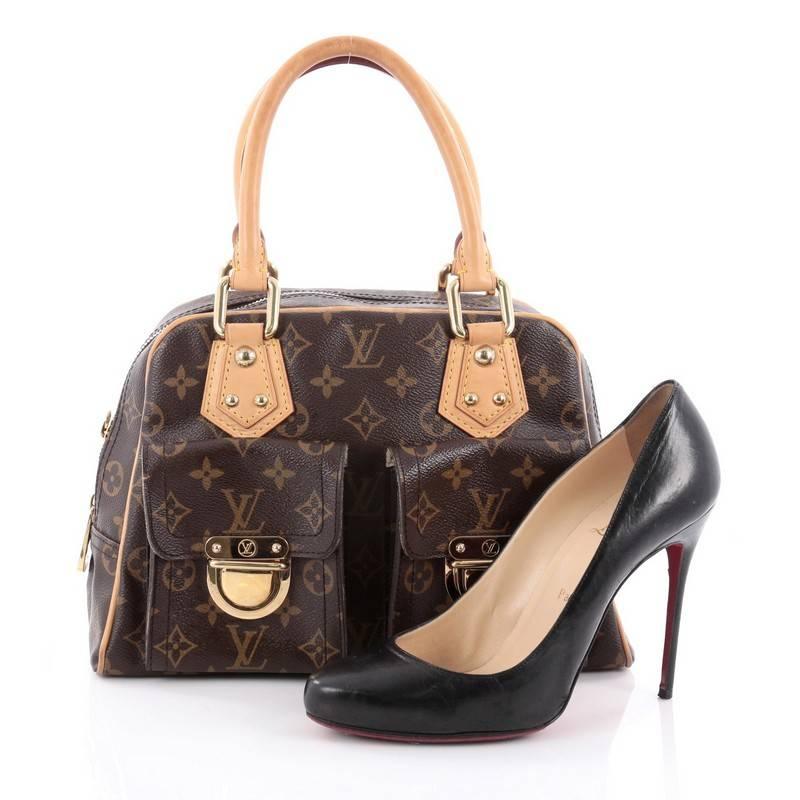This authentic Louis Vuitton Manhattan Handbag Monogram Canvas PM combines style and functionality apt for the modern day woman. Constructed in Louis Vuitton's signature brown monogram coated canvas, this classic satchel features dual-rolled