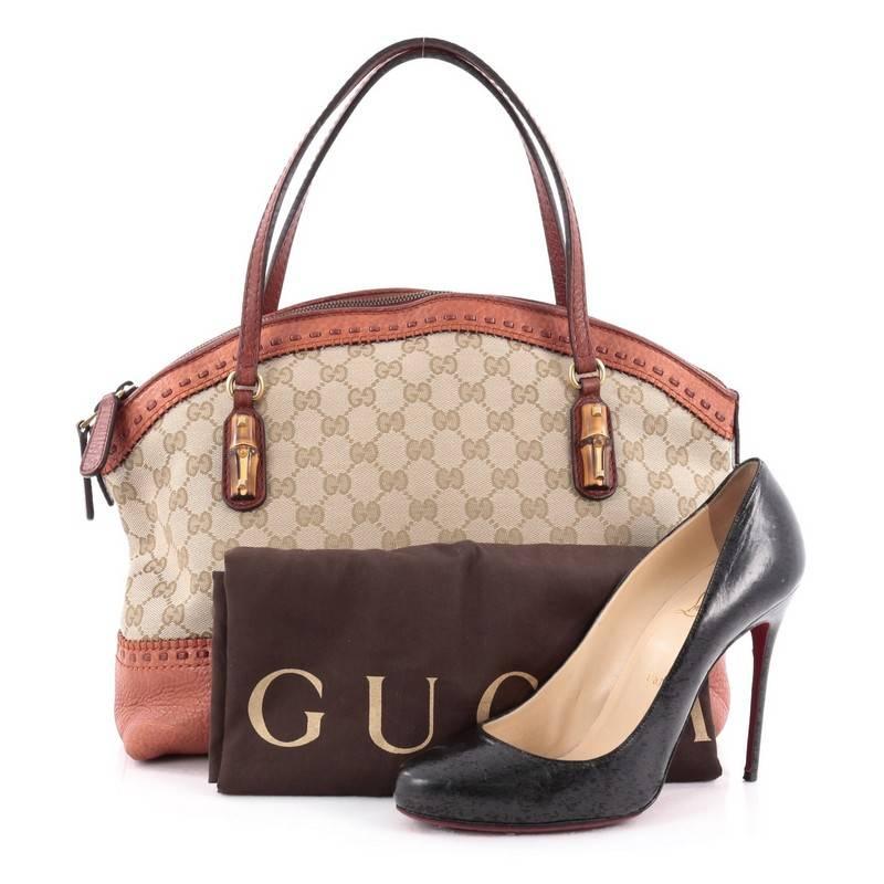 This authentic Gucci Laidback Crafty Handle Bag GG Canvas Medium is a reinterpretation of the brand's rich heritage with modern, yet classic flair. Crafted from brown GG canvas with burnt orange leather trims, this luxurious tote features dual-flat