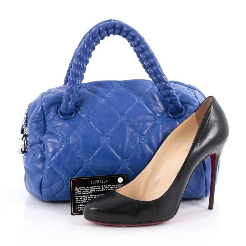 This authentic Chanel Hidden Chain Bowler Quilted Leather Small is something you will want to carry around forever. Crafted from blue quilted leather, this classic and timeless bag features dual-hidden chain handles, CC charm zipper pull, two