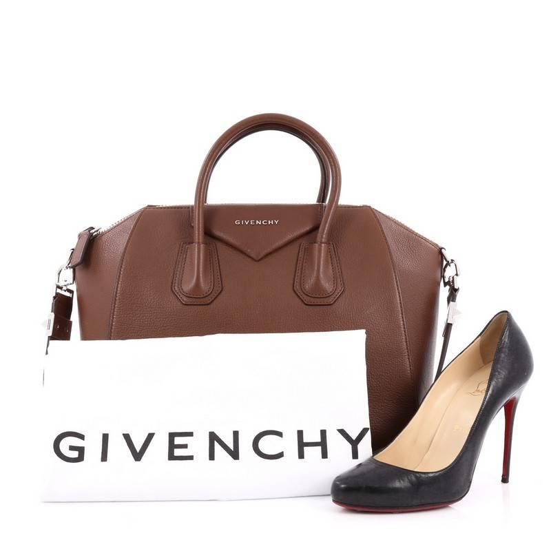 This authentic Givenchy Antigona Bag Leather Medium is a go-to fashion favorite. Crafted from brown leather, this structured yet stylish tote features the brand's signature envelope flap detail with Givenchy logo, dual-rolled leather handles and