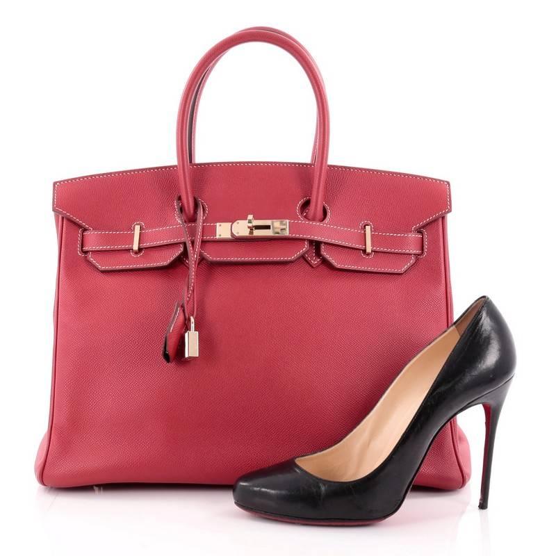 This authentic Hermes Candy Birkin Handbag Epsom 35, presented in the brand's limited candy collection, stands as one of the most-coveted accessory made for the modern woman. Crafted from rouge casaque leather, this stand-out tote features