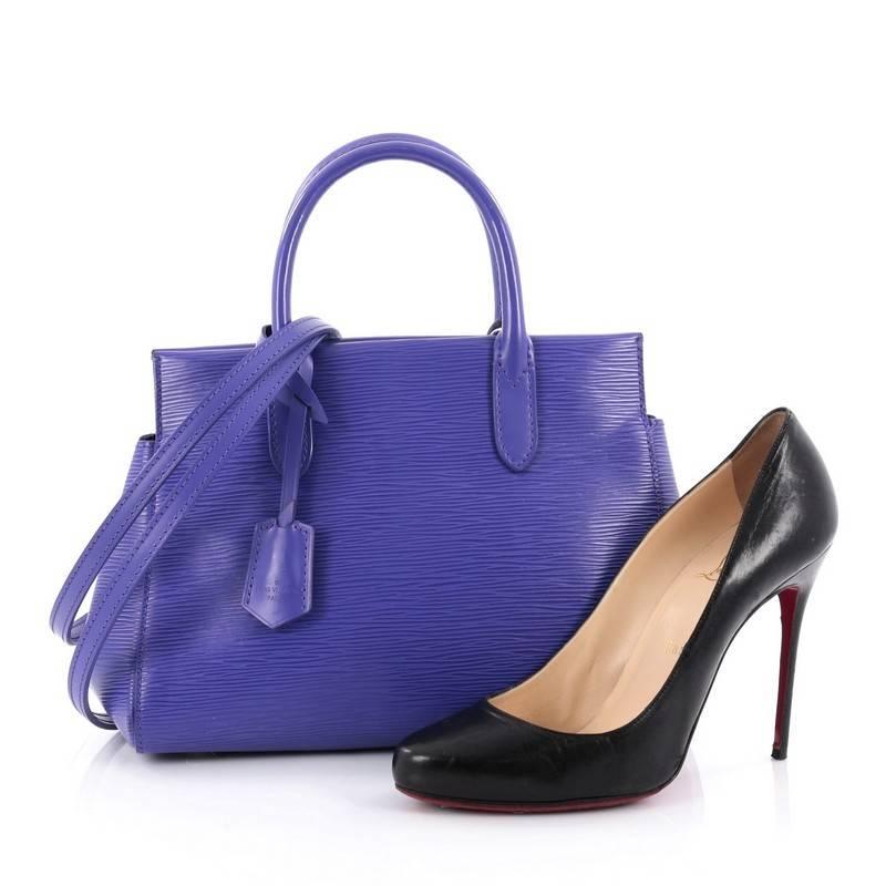 This authentic Louis Vuitton Marly Handbag Epi Leather BB exudes casual sophistication perfect for the modern woman. Crafted in sturdy purple epi leather, this structured working tote features an angular silhouette, dual-rolled leather handles,