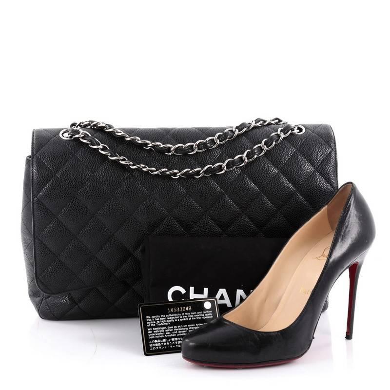 This authentic Chanel Classic Double Flap Bag Quilted Caviar Maxi exudes a classic yet easy style made for the modern woman. Crafted from black caviar leather, this elegant flap features Chanel's signature diamond quilted design, woven-in leather