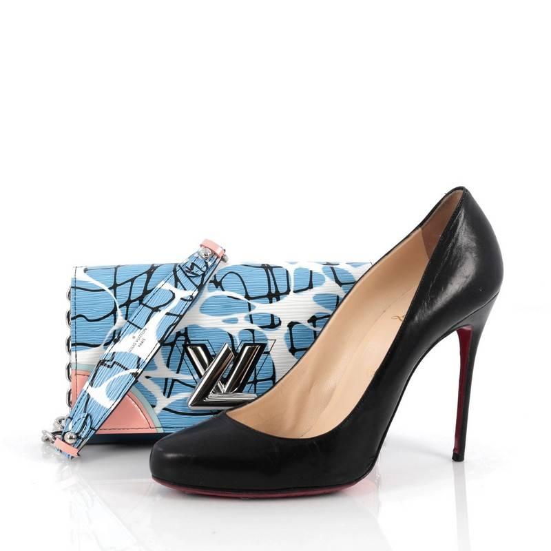 This authentic Louis Vuitton Twist Chain Wallet Limited Edition Aqua Print Epi Leather is unique and modern in design perfect for LV lovers. Crafted in multi-color Aqua Print epi leather and blue patent leather, this wallet features a silver LV