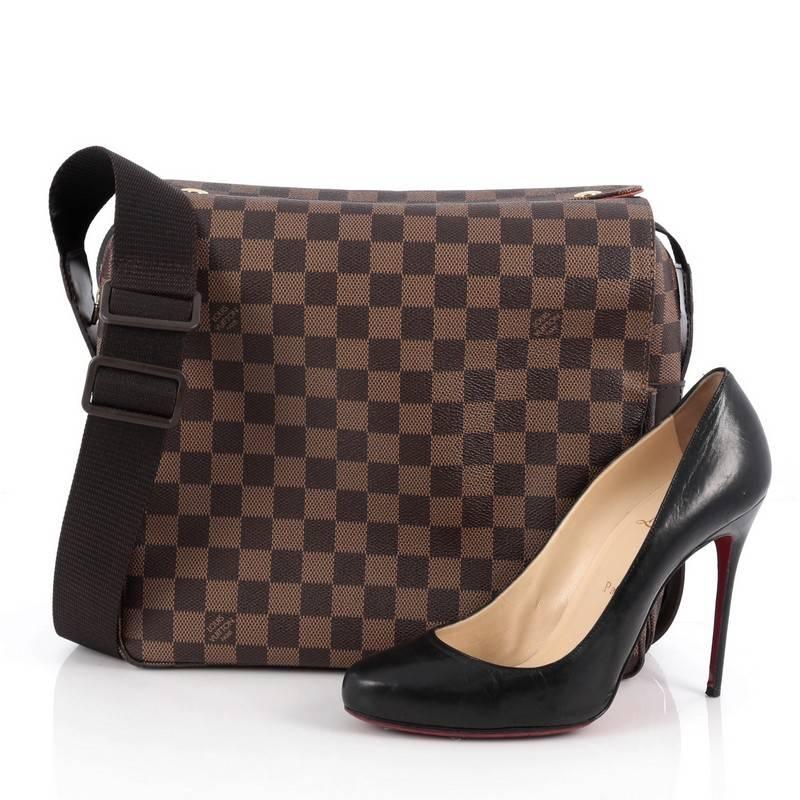 This authentic Louis Vuitton Naviglio Handbag Damier is perfect for the style conscious man or woman on the go. Crafted from brown ebene coated canvas, this elegant bag features wide canvas adjustable strap, large dual flap design and gold-tone