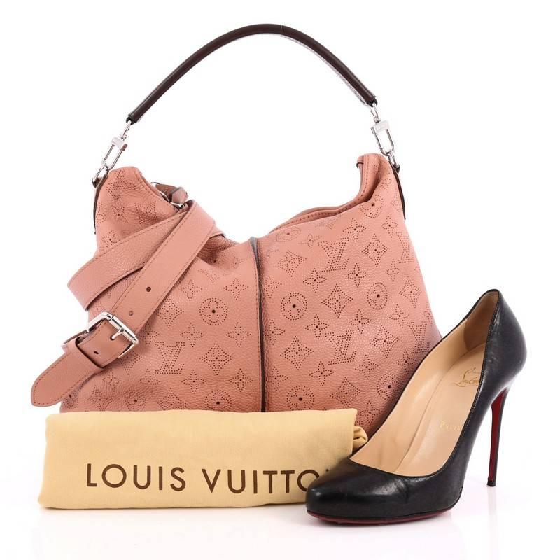 This authentic Louis Vuitton Selene Handbag Mahina Leather PM showcased in the brand's Spring/Summer 2013 collection is a luxe, feminine design. Crafted from pink monogram perforated mahina leather, this beautiful hobo features a single loop leather