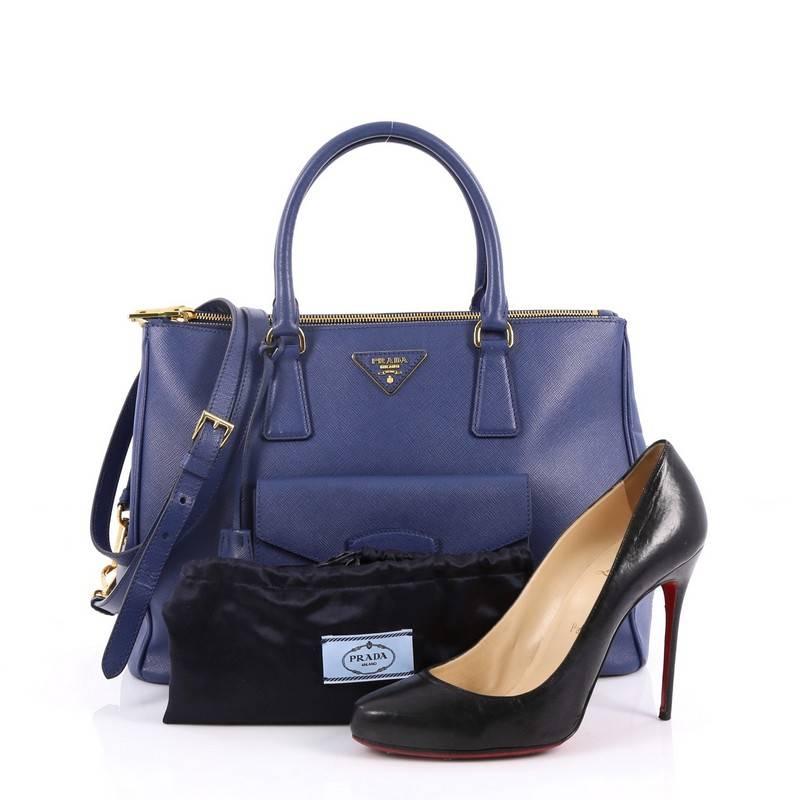 This authentic Prada Front Pocket Double Zip Lux Tote Saffiano Leather Medium is a stylish luxury. Crafted from blue saffiano leather, this boxy tote features side snap buttons, raised Prada logo, dual-rolled leather handles, exterior front pocket